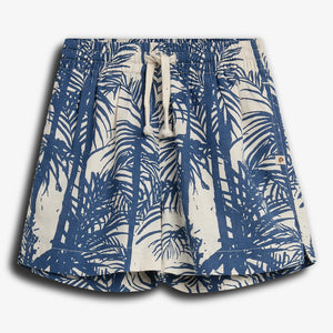 Shorts with blue palm tree prints stand out; the drawstring waist is tied in a bow. They're set against a plain white background, emphasizing their casual, tropical vibe.