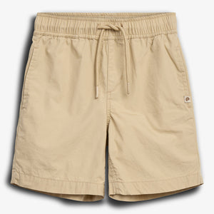 Beige shorts with an elastic waistband and drawstring, displayed on a plain white background. A small logo is visible near the right hem, adding a subtle design element.