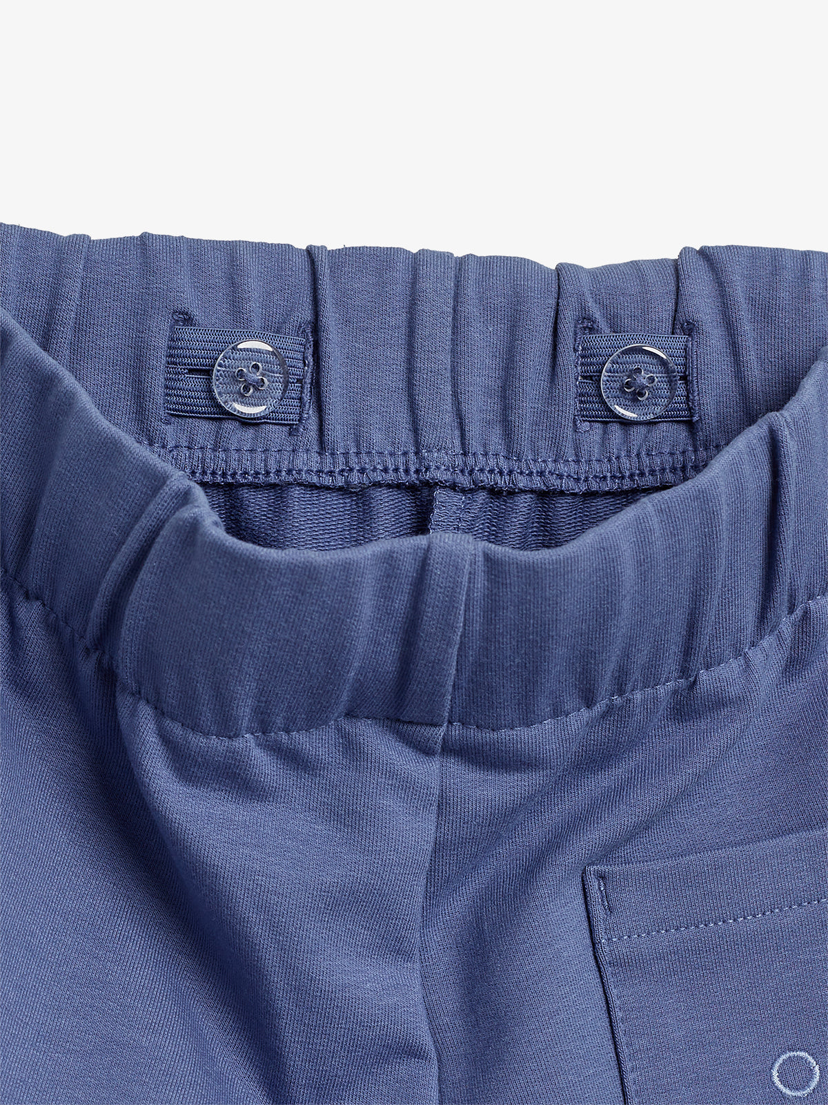 Blue elastic waistband pants featuring button fasteners on the inside, set against a white background.