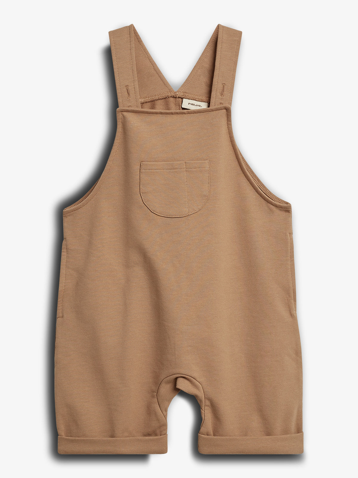 Brown toddler overalls hang against a white background, featuring a front pocket and adjustable straps. The label inside reads "petit lucas."
