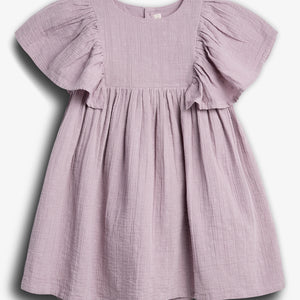 A lilac-colored, short-sleeved dress hangs against a plain white background, featuring a textured fabric with small embroidered patterns and a gathered, flowing skirt.