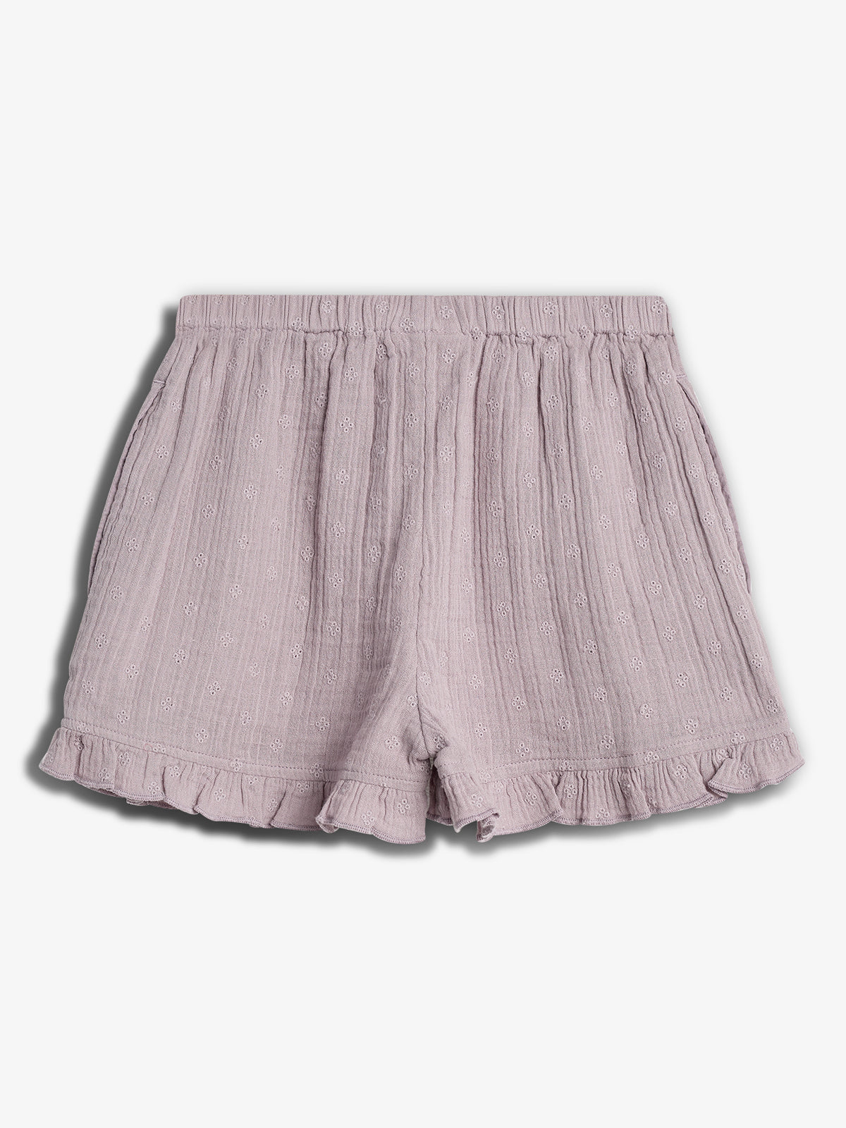 Lilac shorts feature an elastic waistband and ruffled hem. The fabric has a subtle textured pattern with small floral designs, set against a plain white background.