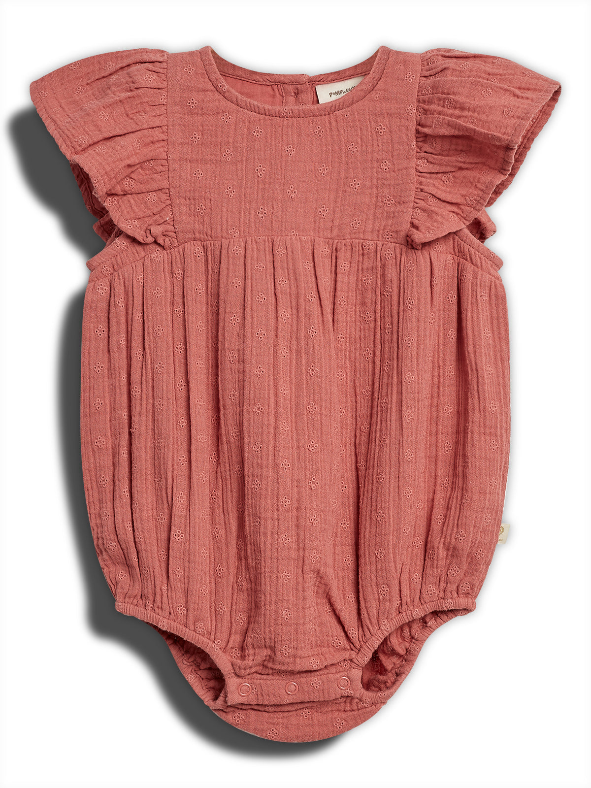 A pink baby romper with ruffled sleeves, featuring small embroidered patterns, lies flat against a white background. It has buttons at the bottom for fastening and a visible inner label.