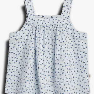 A light blue sleeveless top with thin straps, adorned with a pattern of small blue flowers, displayed against a plain white background.