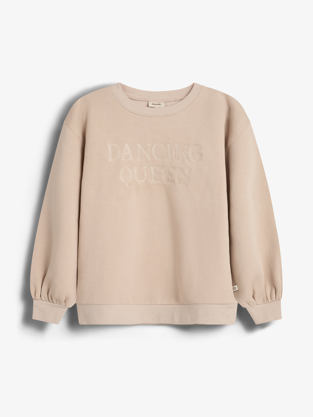 Sweatshirt displays "DANCING QUEEN" text on the front. It's beige with ribbed cuffs and hem, positioned against a plain white background.