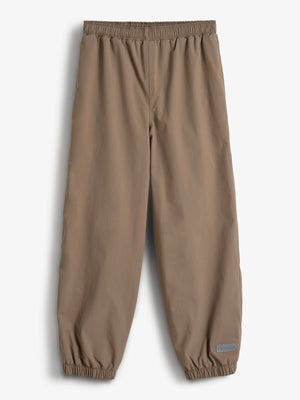 Brown pants with elastic waist and cuffs are laid flat on a white background. A small patch on the lower right leg reads "Porte à Clic."